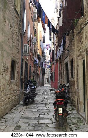 Motor scooter parked in narrow lane, Rovinj, Croatia View Large Photo Image Picture - Motor scooter parked in narrow lane, Rovinj, Croatia. Fotosearch