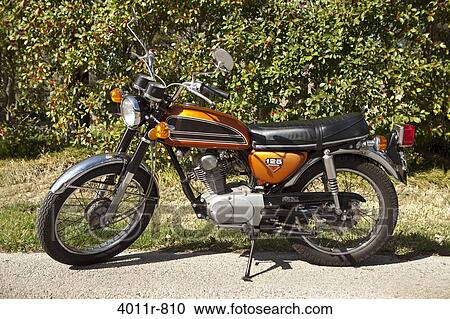 Stock Image - Motorcycle parked outdoors. Fotosearch