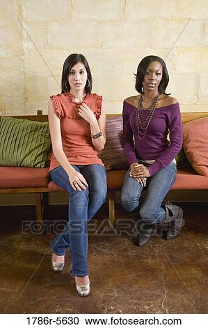 Multiracial women sitting on sofa View Large Photo Image Stock Image - Multiracial women sitting on sofa. Fotosearch