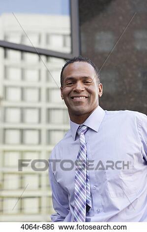 Outdoor portrait of smiling businessman View Large Photo Image Stock Photograph - Outdoor portrait of smiling businessman. Fotosearch