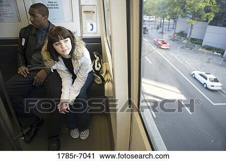 People riding a train View Large Photo Image Stock Image - People riding a train. Fotosearch