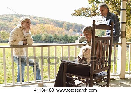 People with dog relaxing on porch in rural landscape View Large Photo Image Stock Image - People with dog relaxing on porch in rural landscape. Fotosearch