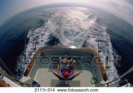 Person sitting in a boat View Large Photo Image Picture - Person sitting in a boat. Fotosearch