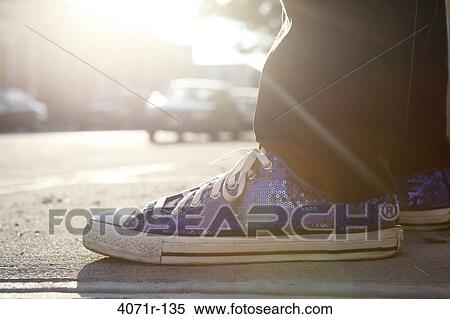 Person standing on city sidewalk wearing sneaker with sequins View Large Photo Image Stock Photography - Person standing on city sidewalk wearing sneaker with sequins. Fotosearch