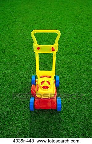 Plastic toy lawn mower View Large Photo Image Stock Photo - Plastic toy lawn mower. Fotosearch
