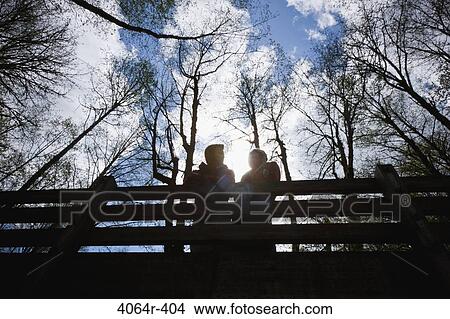 Picture - Portland, Oregon, USA, Couple on bridge in forest. Fotosearch