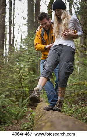 Portland, Oregon, USA, Couple walking along log in forest View Large Photo Image Stock Photo - Portland, Oregon, USA, Couple walking along log in forest. Fotosearch