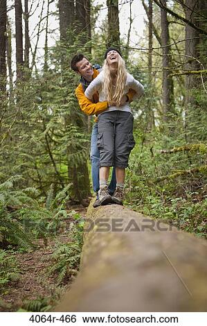 Portland, Oregon, USA, Couple walking along log in forest View Large Photo Image Stock Photograph - Portland, Oregon, USA, Couple walking along log in forest. Fotosearch