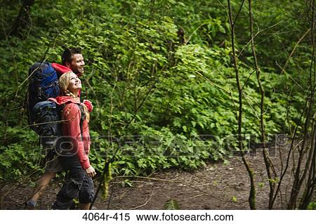 Stock Photography - Portland, Oregon, USA, Couple walking on trail through forest. Fotosearch