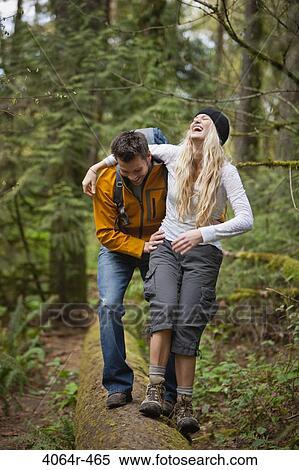 Portland, Oregon, USA, Couple walking along log in forest View Large Photo Image Stock Photography - Portland, Oregon, USA, Couple walking along log in forest. Fotosearch