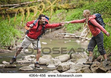 Portland, Oregon, USA, Man helping woman across creek View Large Photo Image Stock Photograph - Portland, Oregon, USA, Man helping woman across creek. Fotosearch