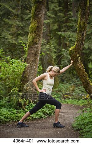 Portland, Oregon, USA, Woman stretching before run, on trail in forest View Large Photo Image Stock Image - Portland, Oregon, USA, Woman stretching before run, on trail in forest. Fotosearch
