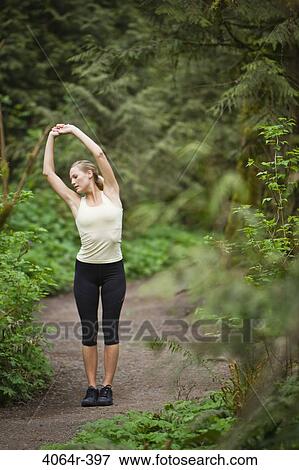 Portland, Oregon, USA, Woman stretching before run, on trail in forest View Large Photo Image Stock Photo - Portland, Oregon, USA, Woman stretching before run, on trail in forest. Fotosearch