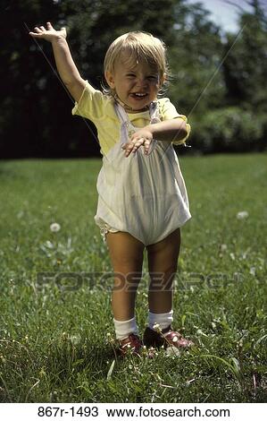 Stock Image - Portrait of a baby on a lawn. Fotosearch