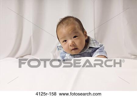 Portrait of a baby on the bed View Large Photo Image Stock Photo - Portrait of a baby on the bed. Fotosearch