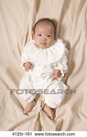 Portrait of a baby smiling on the bed View Large Photo Image Stock Image - Portrait of a baby smiling on the bed. Fotosearch