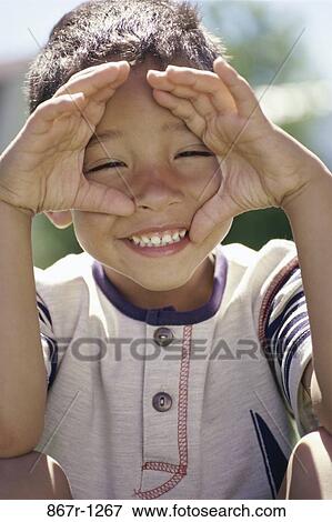 Portrait of a boy making a face View Large Photo Image Stock Photo - Portrait of a boy making a face. Fotosearch
