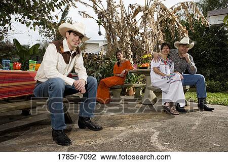 Portrait of a cheerful Tex-Mex family sitting together in the backyard of house View Large Photo Image Stock Image - Portrait of a cheerful Tex-Mex family sitting together in the backyard of house. Fotosearch
