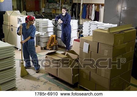 Portrait of a man and a woman in coveralls working in a warehouse View Large Photo Image Stock Image - Portrait of a man and a woman in coveralls working in a warehouse. Fotosearch