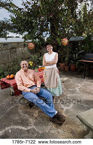 Portrait of a mature couple in front of a picnic table View Large Photo Image Stock Image - Portrait of a mature couple in front of a picnic table. Fotosearch