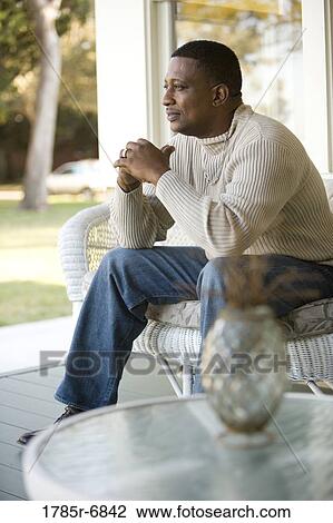Portrait of a mature man sitting on porch View Large Photo Image Stock Image - Portrait of a mature man sitting on porch. Fotosearch