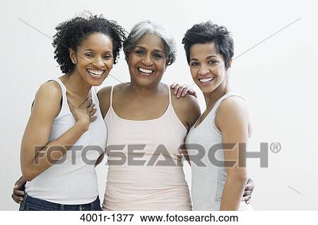 Stock Photo - Portrait of a senior woman with her daughters smiling. Fotosearch