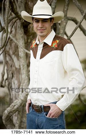 Portrait of a smiling young man in a Tex-Mex costume with hands in pocket View Large Photo Image Stock Image - Portrait of a smiling young man in a Tex-Mex costume with hands in pocket. Fotosearch