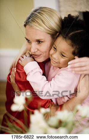 Portrait of a woman and daughter dressed in pajamas, embracing View Large Photo Image Stock Image - Portrait of a woman and daughter dressed in pajamas, embracing. Fotosearch