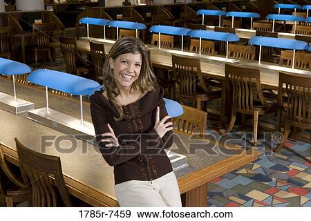 Portrait of a young woman standing in the reading room of a library View Large Photo Image Stock Photo - Portrait of a young woman standing in the reading room of a library. Fotosearch