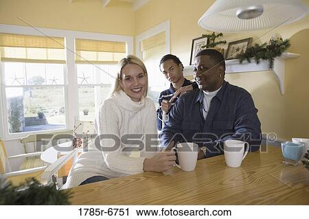 Portrait of an interracial family at home View Large Photo Image Stock Image - Portrait of an interracial family at home. Fotosearch