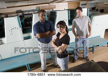 Portrait of blue-collar workers next to a printing press View Large Photo Image Stock Image - Portrait of blue-collar workers next to a printing press. Fotosearch