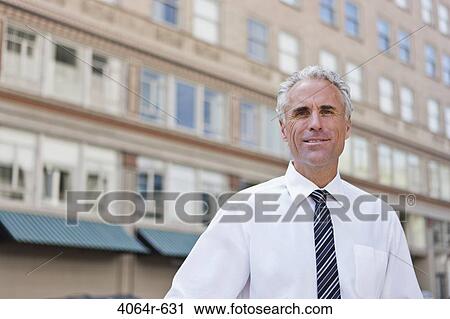 Portrait of businessman outside office in city View Large Photo Image Stock Image - Portrait of businessman outside office in city. Fotosearch