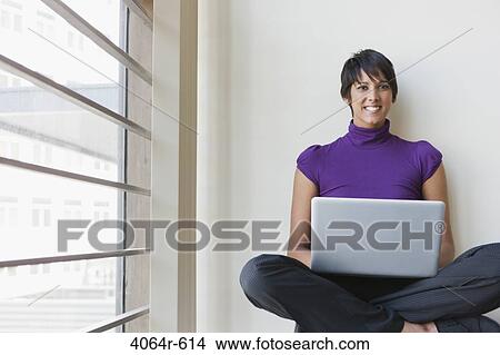 Portrait of businesswoman using laptop in office View Large Photo Image Picture - Portrait of businesswoman using laptop in office. Fotosearch