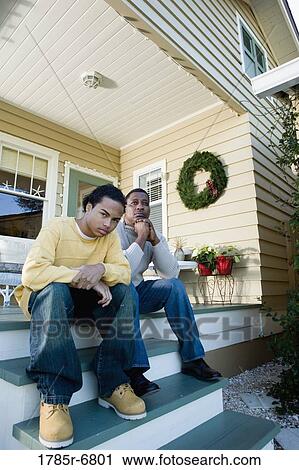 Portrait of father and son sitting on steps of porch View Large Photo Image Stock Image - Portrait of father and son sitting on steps of porch. Fotosearch