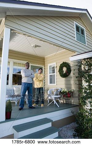 Portrait of father and son standing on porch View Large Photo Image Stock Image - Portrait of father and son standing on porch. Fotosearch