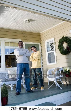 Portrait of father and son standing on porch View Large Photo Image Stock Photo - Portrait of father and son standing on porch. Fotosearch