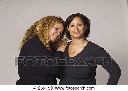 Stock Photo - Portrait of female friends smiling. Fotosearch