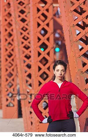 Portrait of female runner on bridge View Large Photo Image Stock Photo - Portrait of female runner on bridge. Fotosearch