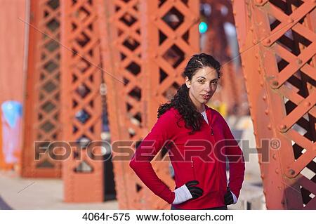 Stock Photography - Portrait of female runner on bridge. Fotosearch