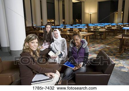 Portrait of four women students in a sitting lounge in a library View Large Photo Image Stock Image - Portrait of four women students in a sitting lounge in a library. Fotosearch