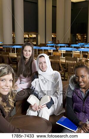 Portrait of four women students in a sitting lounge in a library View Large Photo Image Stock Image - Portrait of four women students in a sitting lounge in a library. Fotosearch