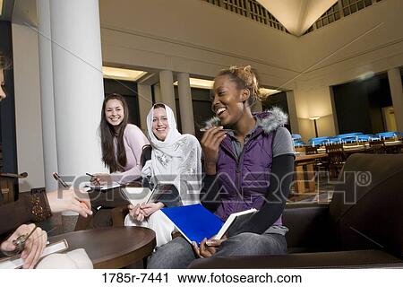 Portrait of four women students in a sitting lounge in a library View Large Photo Image Stock Image - Portrait of four women students in a sitting lounge in a library. Fotosearch
