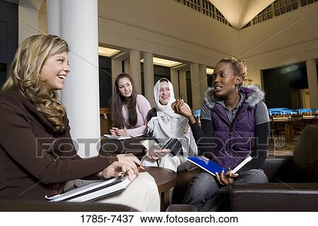 Portrait of four women students in a sitting lounge in a library View Large Photo Image Stock Photo - Portrait of four women students in a sitting lounge in a library. Fotosearch