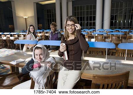 Portrait of four women students in the reading room of a library View Large Photo Image Picture - Portrait of four women students in the reading room of a library. Fotosearch