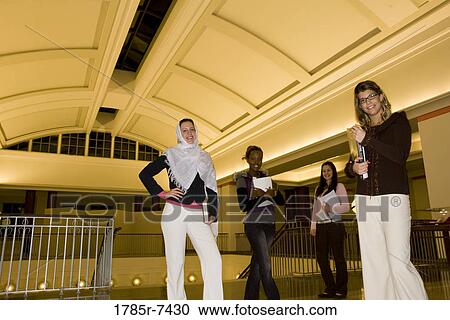 Portrait of four women students standing in the lobby of a building View Large Photo Image Stock Image - Portrait of four women students standing in the lobby of a building. Fotosearch