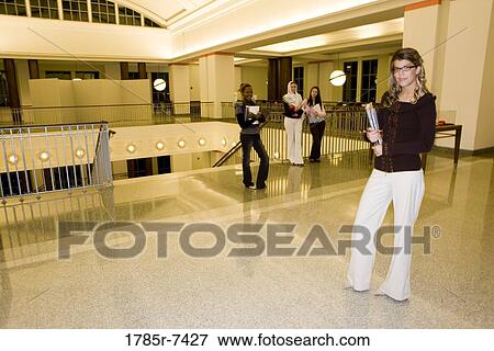 Portrait of four women students standing in the lobby of a building View Large Photo Image Stock Photo - Portrait of four women students standing in the lobby of a building. Fotosearch