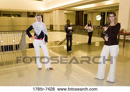 Portrait of four women students standing in the lobby of a building View Large Photo Image Stock Photo - Portrait of four women students standing in the lobby of a building. Fotosearch