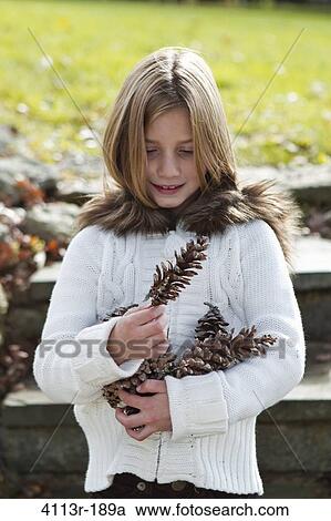 Portrait of girl holding pinecones View Large Photo Image Stock Image - Portrait of girl holding pinecones. Fotosearch