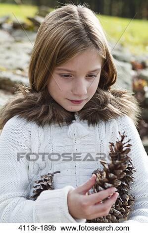 Portrait of girl holding pinecones View Large Photo Image Stock Image - Portrait of girl holding pinecones. Fotosearch