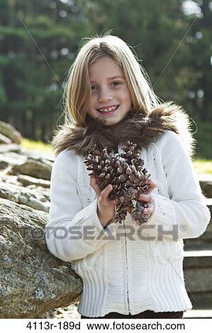 Portrait of girl holding pinecones View Large Photo Image Stock Image - Portrait of girl holding pinecones. Fotosearch